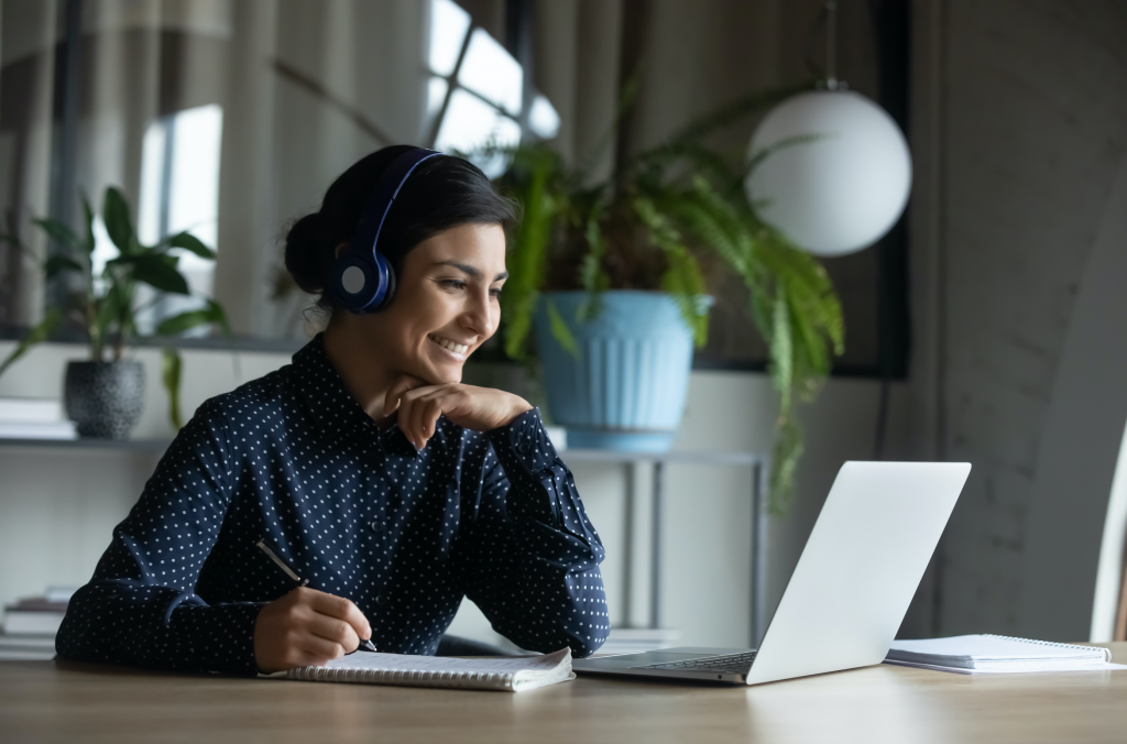 Virtual Events - Image of woman with headset smiling at laptop
